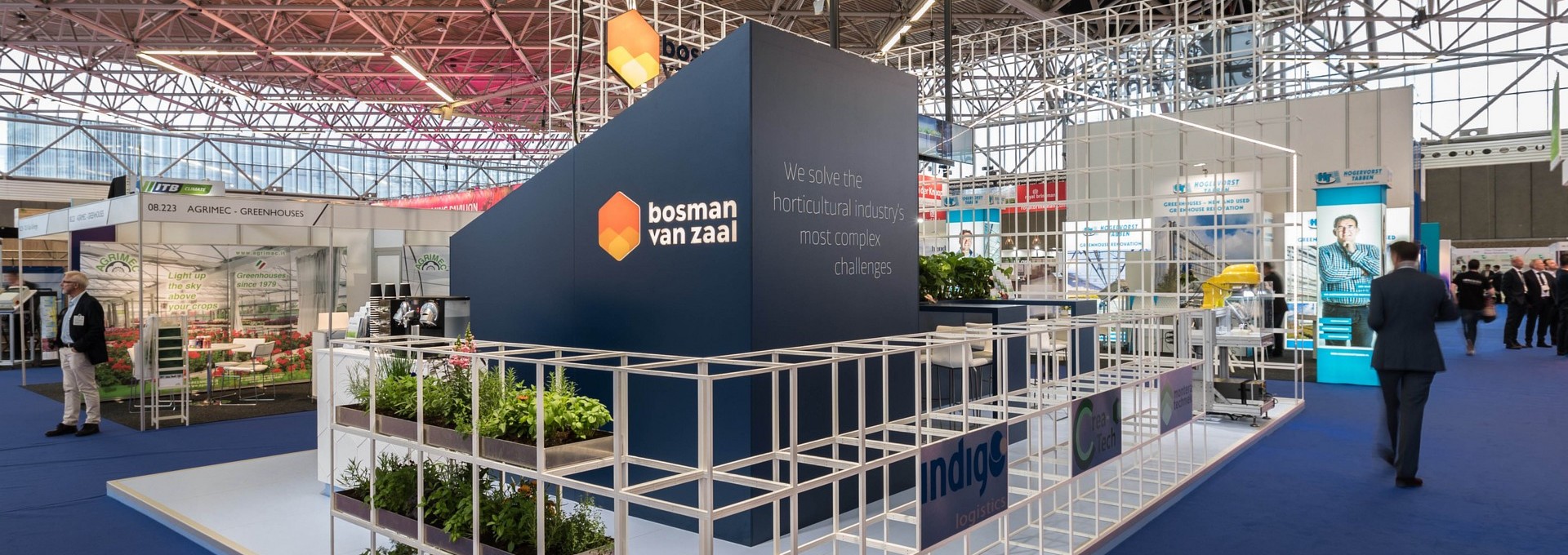 Innovative Exhibition Design for Bosman van Zaal: Modular Brilliance. Explore the future of greenhouse construction with our striking modular booth designed for Bosman van Zaal. This dynamic structure, showcased at various fairs and international exhibitions, embodies the identity of the greenhouse construction company. Design by Studio Königshausen.
